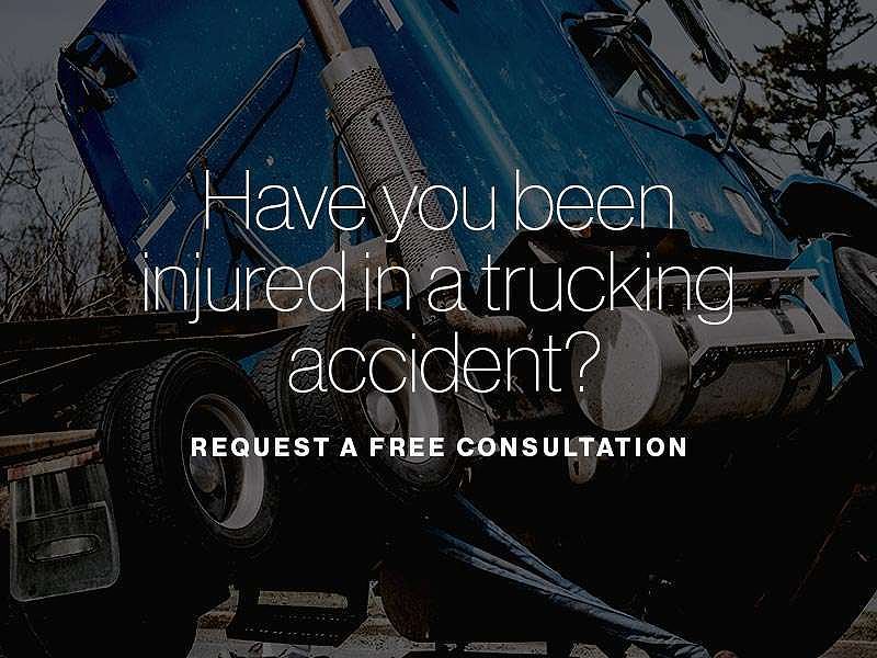 A commercial truck tipped over with the text "Have you been injured in a trucking accident?" superimposed