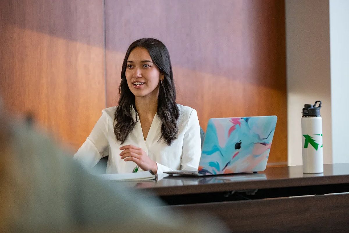 Female MBA student presenting in a conference room